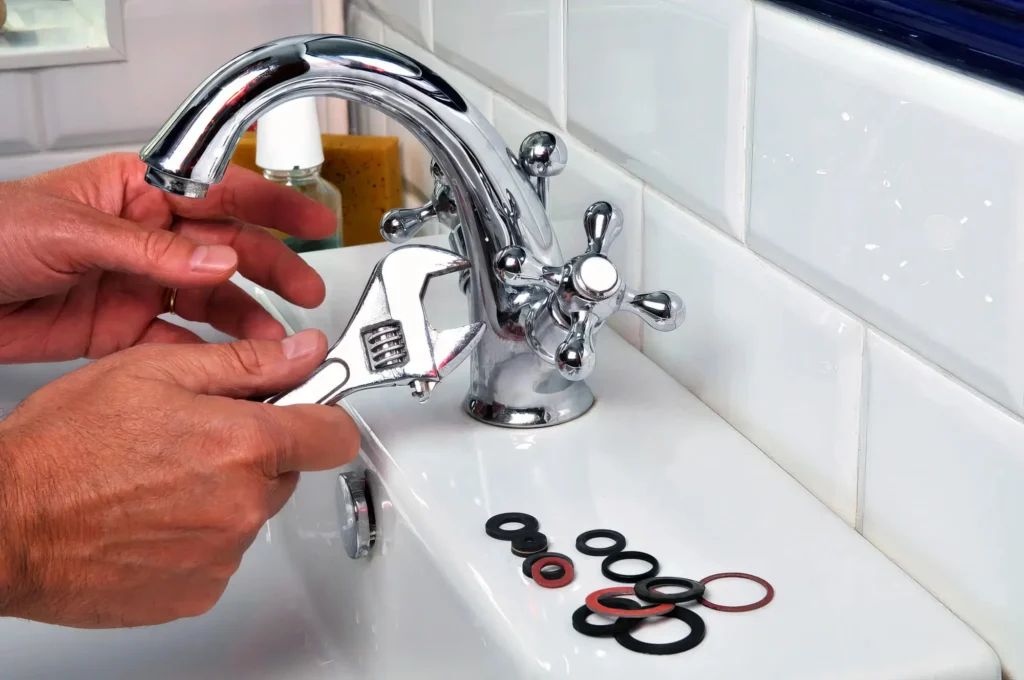Plumber performing maintenance on a bathroom faucet in Bradenton