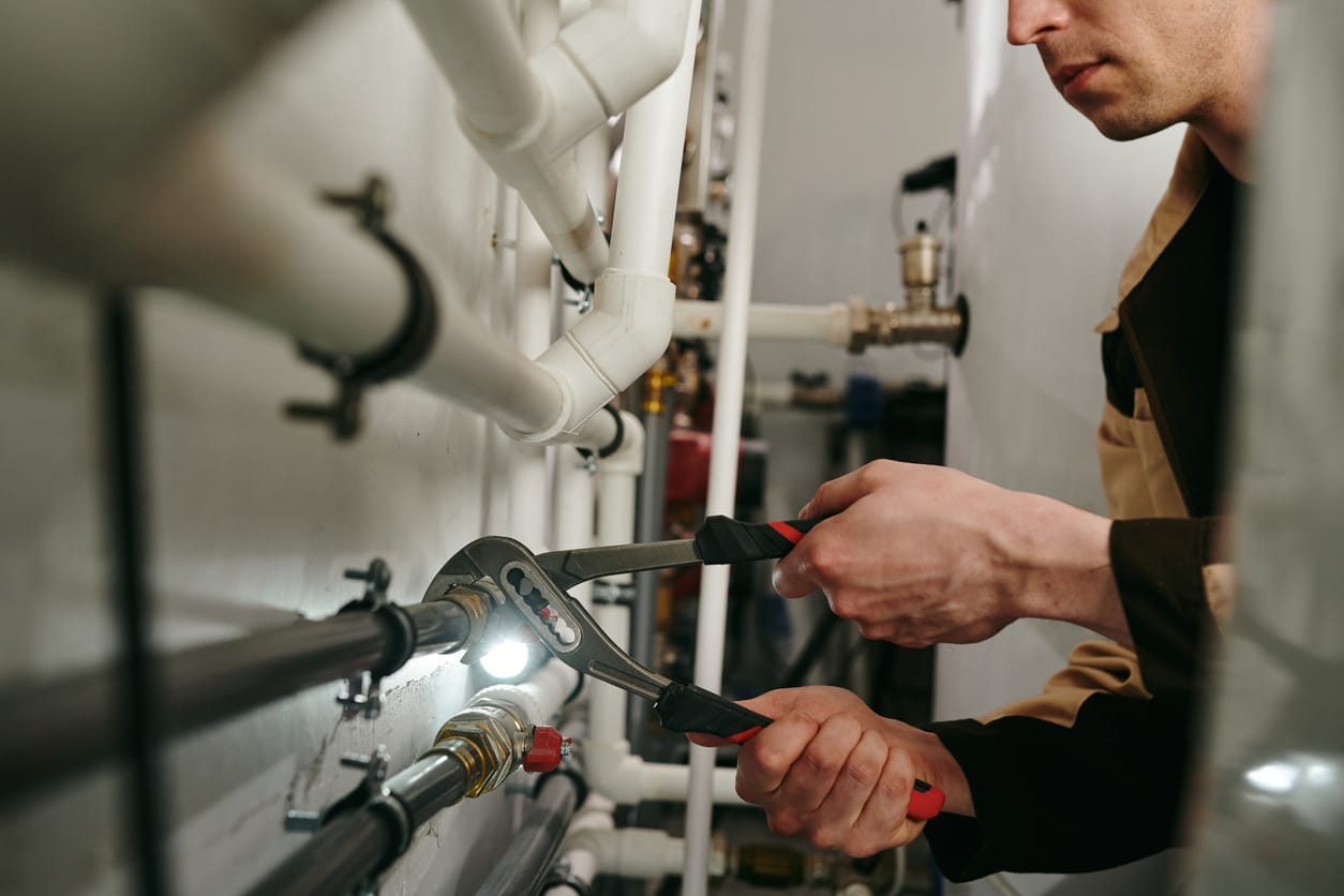 Plumbers maintaining commercial plumbing pipes in Bradenton