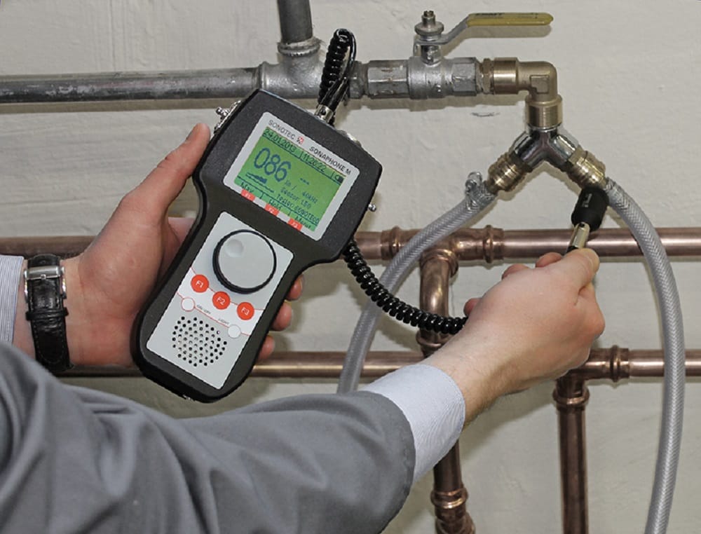 Plumber testing pipes with electronic leak detection equipment in Bradenton