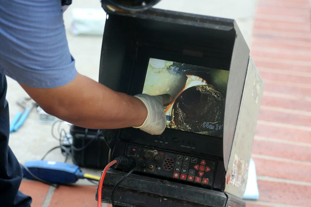 Technician viewing a drain inspection camera in Bradenton