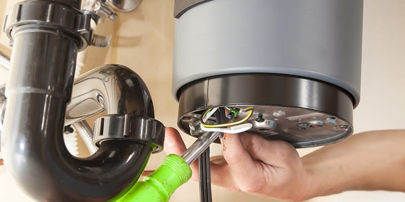 Technician repairing the heating element of a water heater in Bradenton