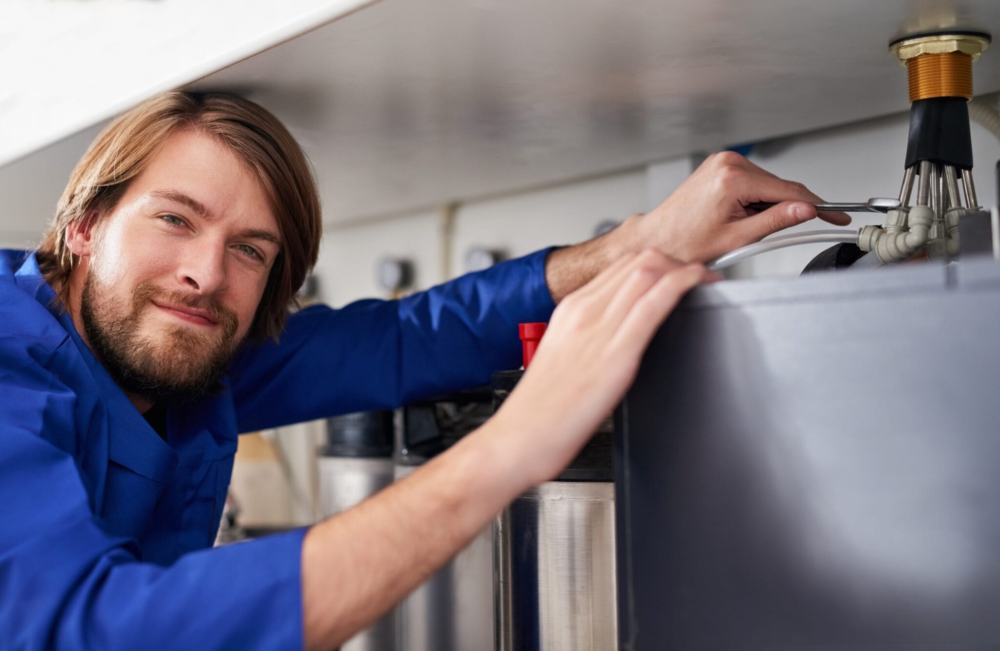 Technician servicing a residential water heater tank in Bradenton