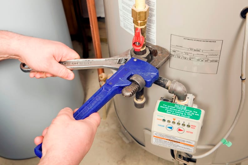 Plumber repairing a water heater valve in Bradenton